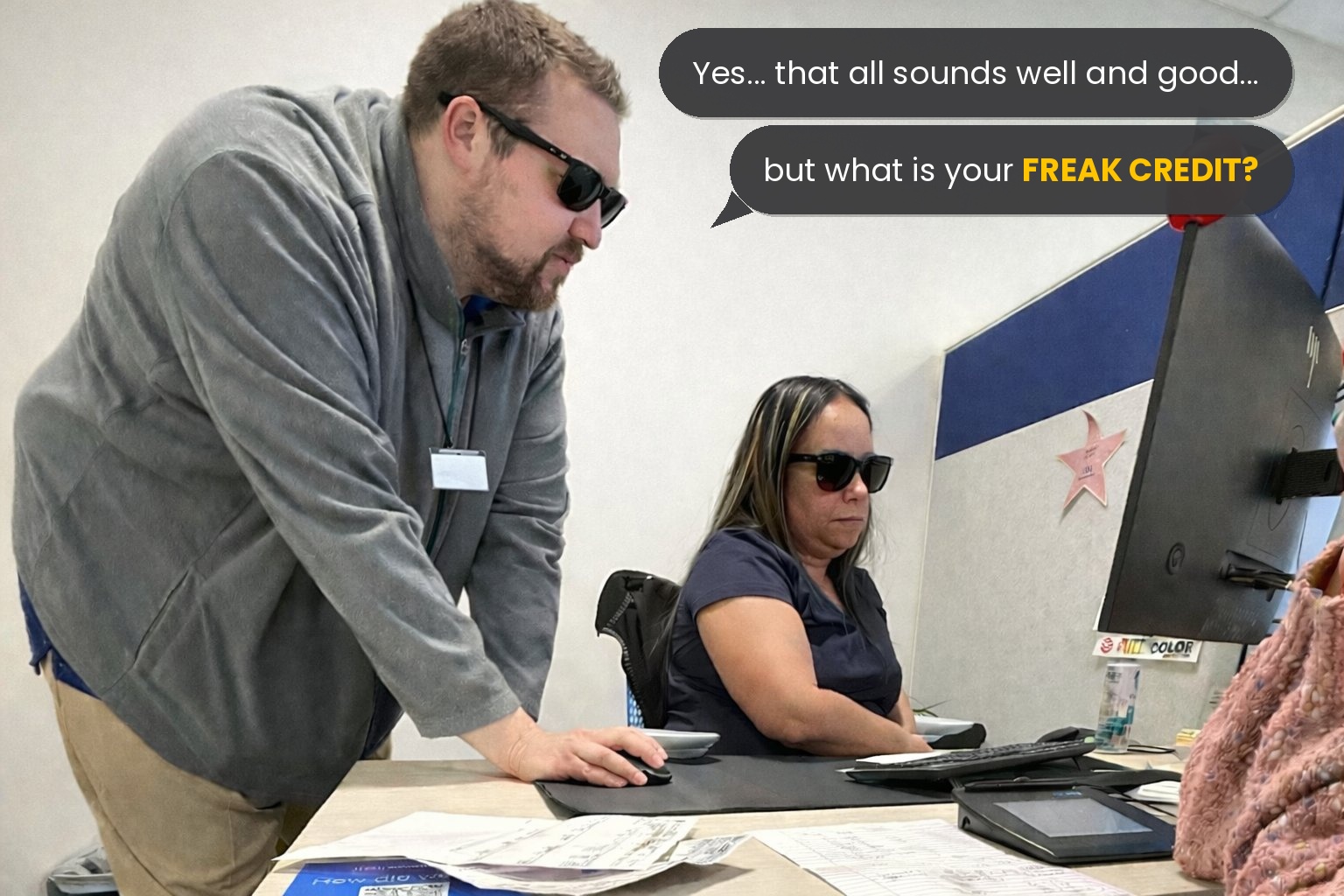 A loan officer in a tight purple disco shirt staring directly at you